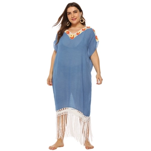 Detail of blue beach dress with handmade crochet neckline and long white fringe
