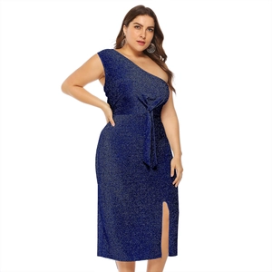 Detail view of navy blue glitter fabric and side slit on the off-shoulder dress
