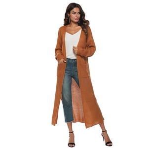 Detail shot of long-sleeved rust orange knit cardigan with functional side pockets