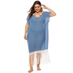 Detail of embroidered neckline and white fringe on a light blue plus size beach dress