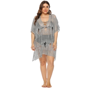 Macro detail of grey crochet knit cover-up showing deep V-neckline and lace-up ties