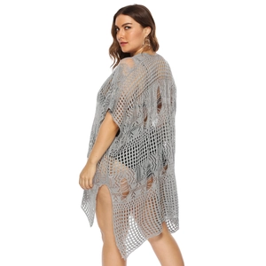 Detail of grey oversized crochet knit beach cover-up featuring hollow-out distressed design