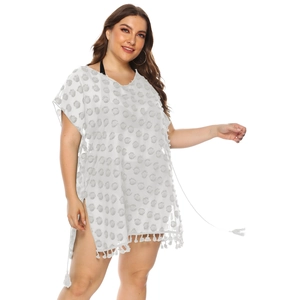 Detail view of semi-transparent white chiffon beach cover-up with tassel trim and V-neckline