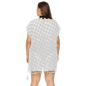 Detail of white chiffon beach cover-up with textured Swiss dots and tassel fringe hem