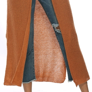 Detail view of the long orange cardigan featuring high side slits and mesh knit texture