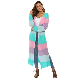 Detail of colorful striped knitted long cardigan featuring large pockets and split sides