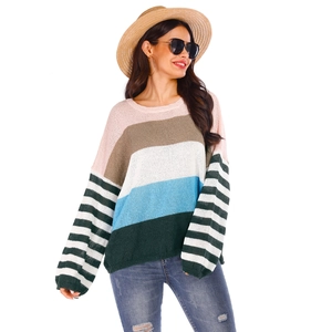 Detail of color-block striped knitted sweater with lantern sleeves and crew neck