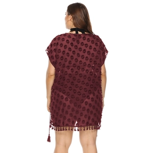 Detail of wine red chiffon cover-up featuring 3D dot textures and tassel hem design