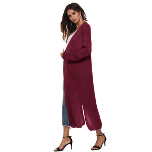 Close-up of deep wine red long knit cardigan featuring large pockets and cozy texture