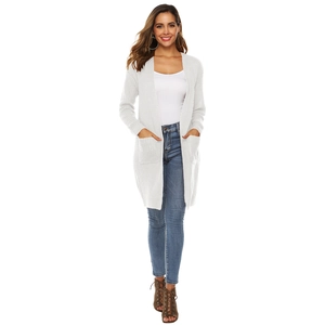 Detail of white long-line chunky knit cardigan with large pockets and open front design