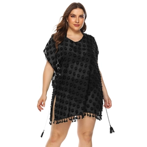 Detail of black chiffon beach cover-up featuring 3D dots and fringe hem texture