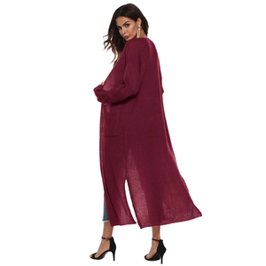 Detailed knit texture of a long burgundy cardigan with elegant side slits and open front