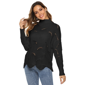 Detail of black knit sweater featuring half-moon hollow patterns and wavy hemline texture