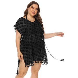 Detail of black chiffon cover-up with textured dots, V-neck design, and fringe hem tassels