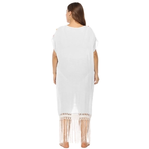 Detail view of the bohemian white beach dress with crochet lace neck and long fringe hem