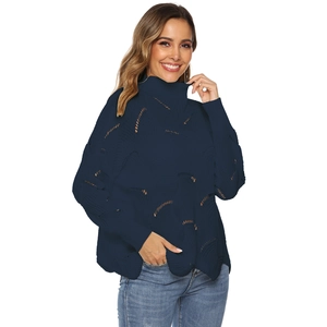Close-up of deep blue knitted sweater featuring wavy hollow patterns and turtleneck detail