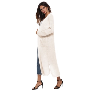 Detail view of long cream knit cardigan showing the soft texture and side slit design