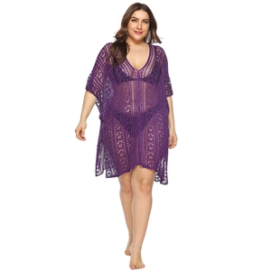 Close-up of purple crochet beach cover-up featuring intricate V-neck hollow lace patterns