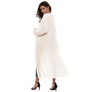 Detail view of long cream knit cardigan with side slits and practical patch pockets