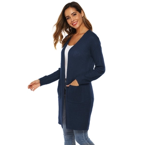 Detail shot of navy blue knit cardigan with large side pockets and ribbed texture
