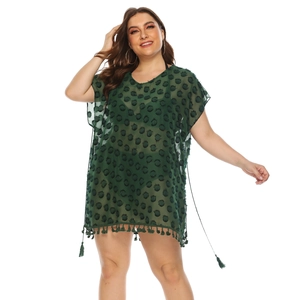 Detail of dark green V-neck chiffon beach cover-up with fringe trim and flocked dots