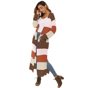 Detail view of a long striped knit cardigan with color blocking and high side slits