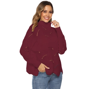 Detail view of burgundy knitted sweater featuring hollow-out pattern and cozy turtleneck