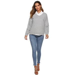Detail of grey V-neck knit sweater with white shirt collar and ribbed cuffs for women