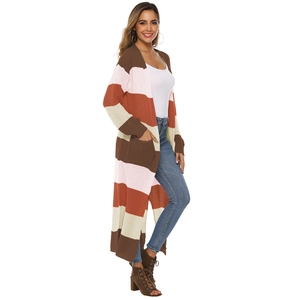 Close-up detail of knitted oversized cardigan with colorful stripes and large pockets