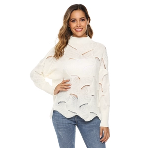 Close-up of hollow knit texture and wavy pattern on a white high-neck sweater