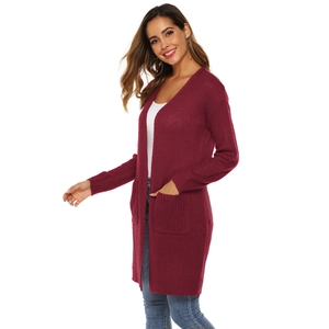 Close-up of wine red chunky knit cardigan featuring large front pockets and thick texture