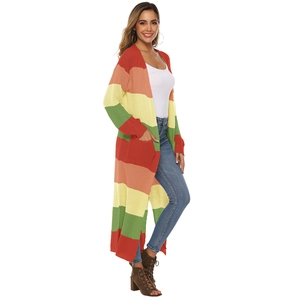 Detail of colorful rainbow striped knit cardigan with deep pockets and soft texture