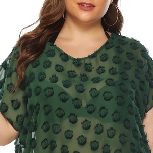 Detail of dark green V-neck chiffon dress featuring 3D dot fringe texture and batwing sleeves