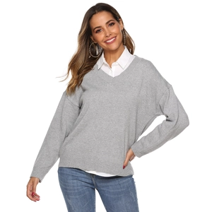 Close-up of light gray V-neck knitted sweater paired with a white collared shirt