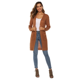 Detail view of a long-sleeved brown knit cardigan with large pockets on a model