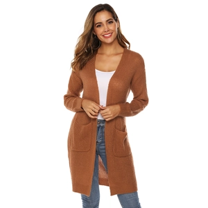 Detail of caramel knit cardigan showing soft ribbed texture and large square pocket