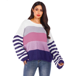 Detailed close-up of textured knit color-block sweater with striped patterns and dropped shoulders