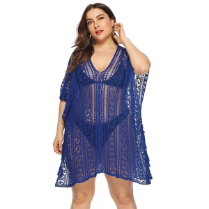 Detail of blue crochet beach cover-up featuring geometric hollow patterns and V-neckline
