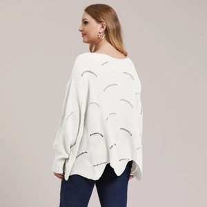 Close-up of white hollow-out knit sweater with wave-pattern texture and loose fit
