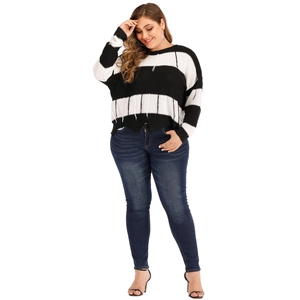 Detail of plus size striped knit sweater with unique white vertical hem fringe trim