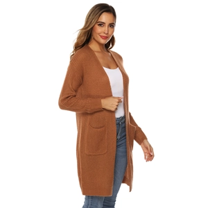 Detail of caramel brown knit cardigan featuring large side pockets and ribbed cuffs