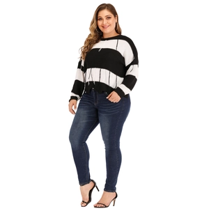 Detail view of plus size striped knit sweater featuring unique fringe thread textures