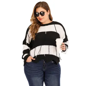 Detail of plus size striped knit sweater featuring unique fringe hem and tassels