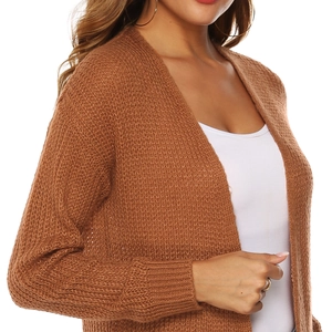 Close-up of brown long-sleeved knit cardigan showing hollow out crochet texture detail
