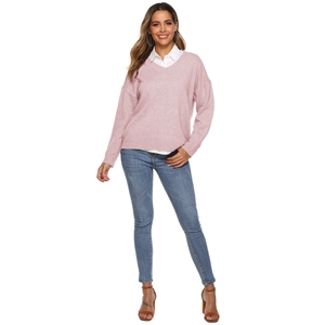 Pink V-neck knitted sweater layered with white shirt and blue jeans for casual office wear