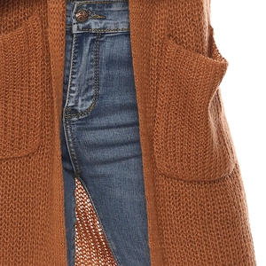 Detail view of caramel chunky knit cardigan texture with large pocket and denim jeans