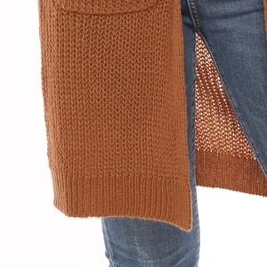 Detail of caramel chunky knit cardigan showing the textured mesh pattern and cozy fabric