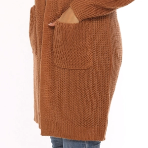 Detail of brown chunky knit cardigan featuring large side pocket and textured fabric