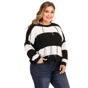 Chic black and white striped oversized knitted sweater with fringe details and long sleeves