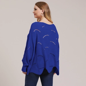 Detail of royal blue knit sweater with openwork wave pattern and batwing sleeves design